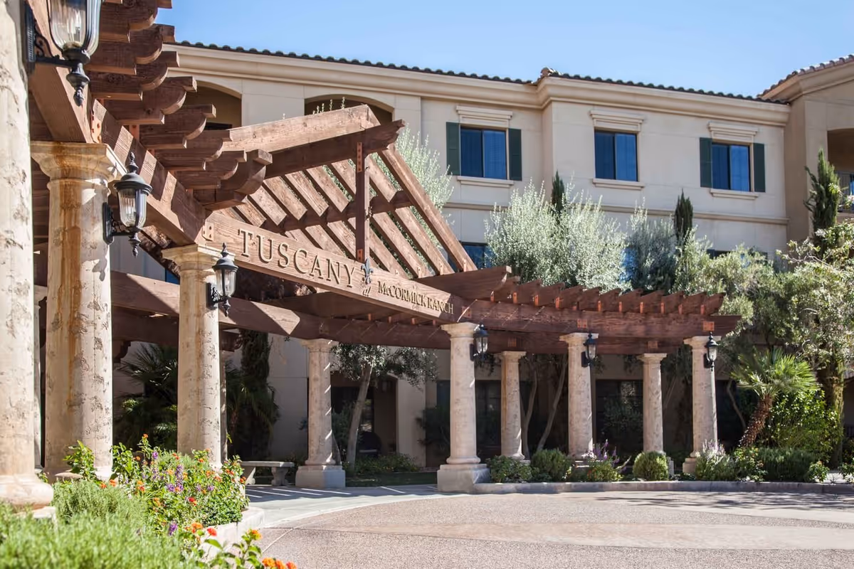 Stone columns support a wooden pergola at Tuscany at McCormick Ranch entrance.