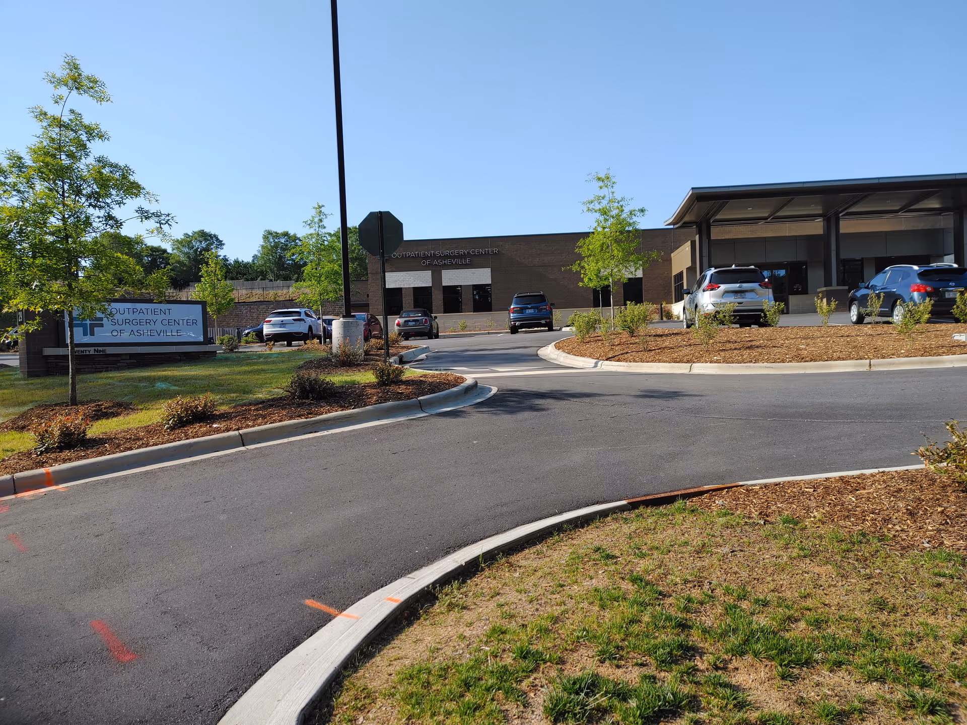 Exterior view of Outpatient Surgery Center of Asheville with parking lot and trees