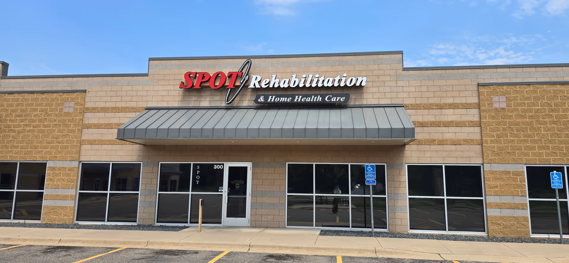 Exterior view of SPOT Rehabilitation and Home Health Care building with entrance and signage.