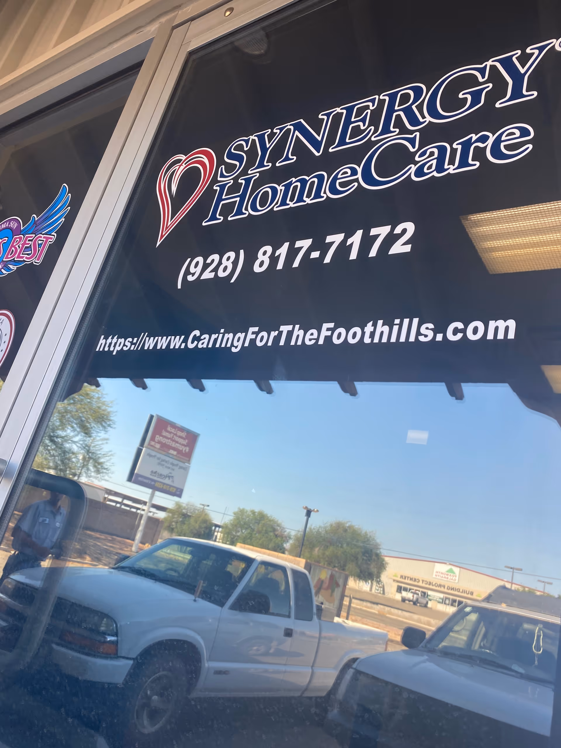 Front of building shows SYNERGY HomeCare signage, phone number, and website.
