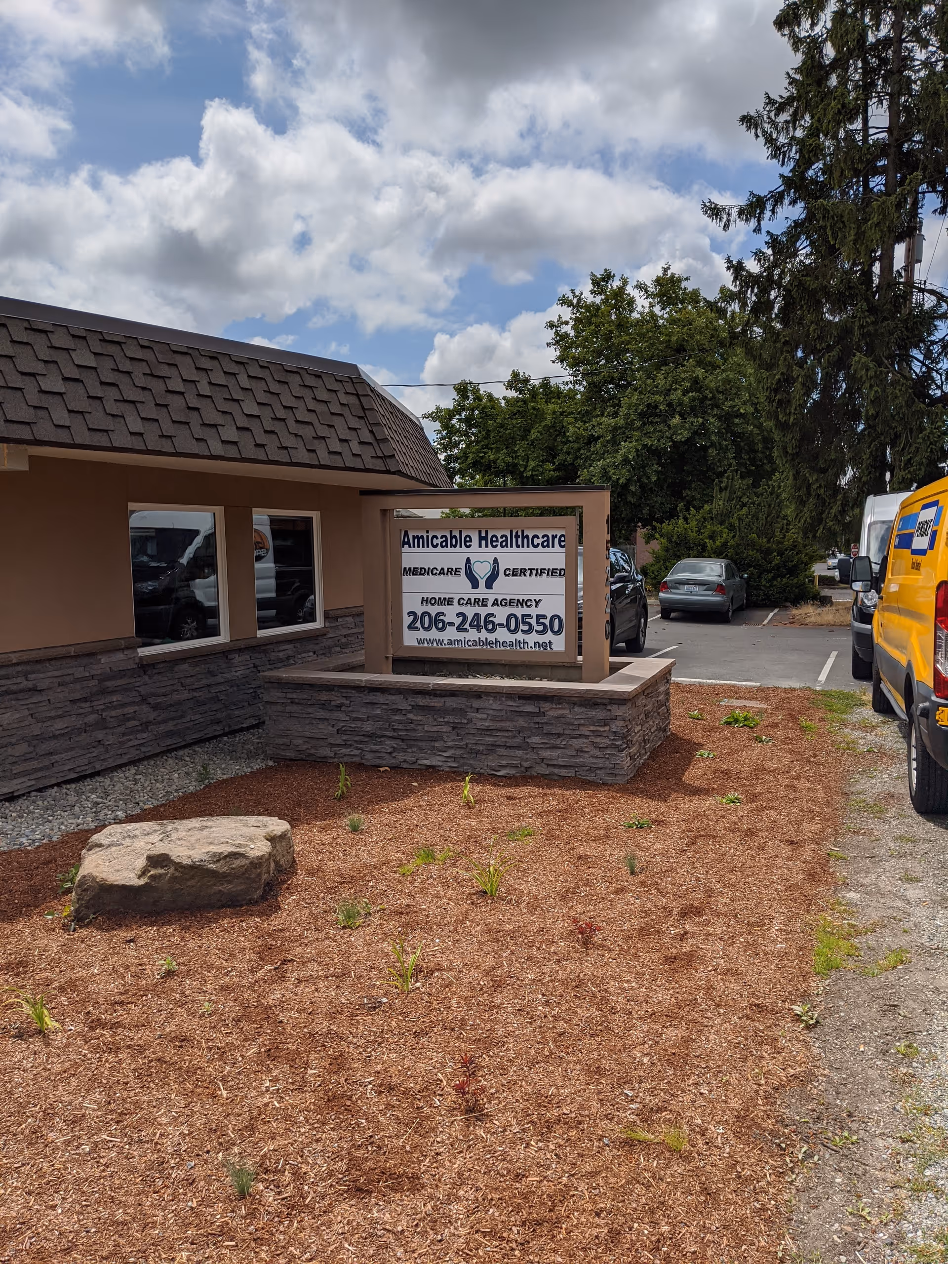 Front view of Amicable Healthcare building with sign and parking lot.