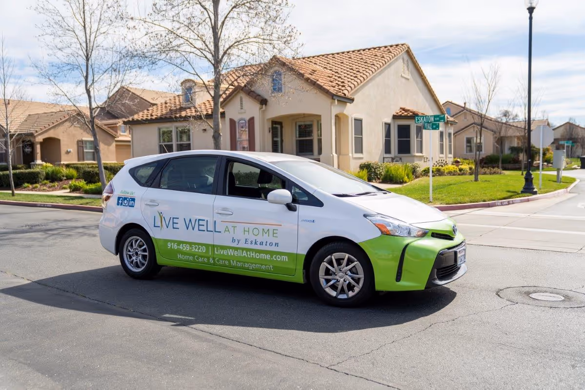 White and green Live Well at Home by Eskaton van parked on a suburban street