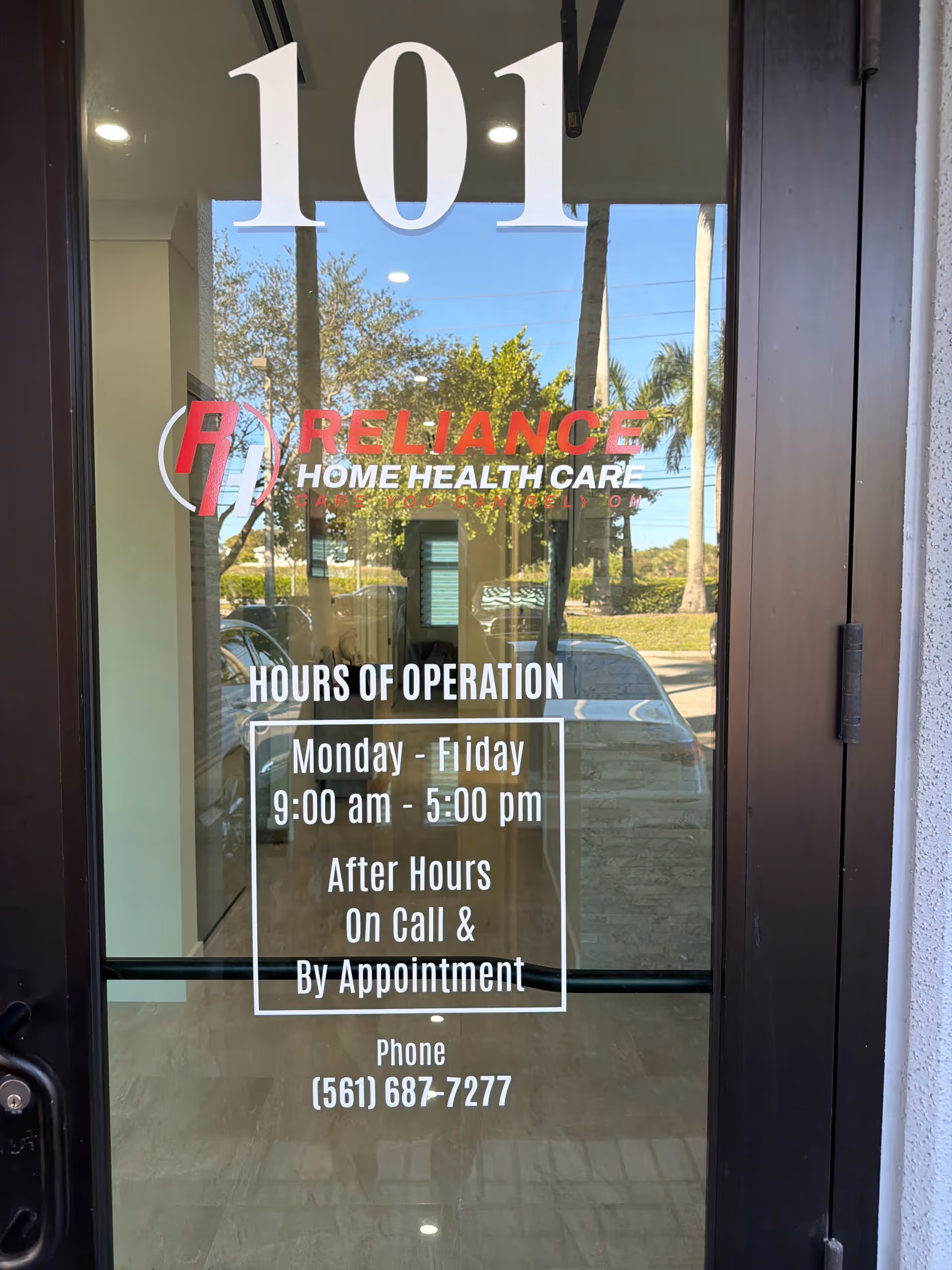 Glass entrance door displays Reliance Home Health Care and hours of operation.