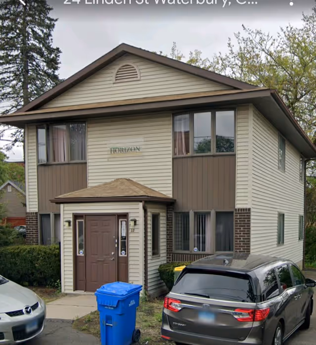 Front view of Horizon Homemaker and Companion facility, two-story beige building with brown accents.