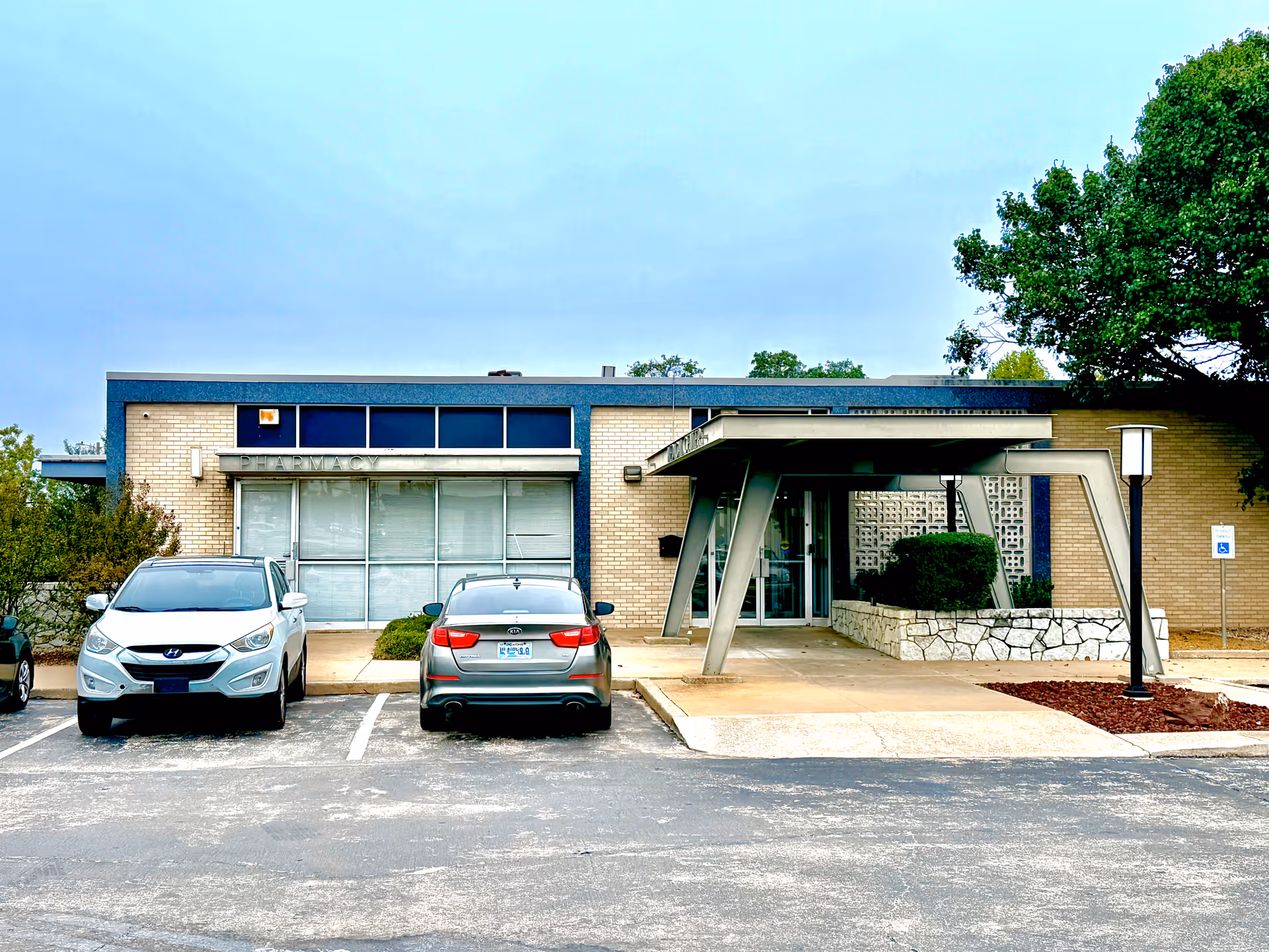 Exterior view of a single-story care facility with blue trim and a covered entrance.