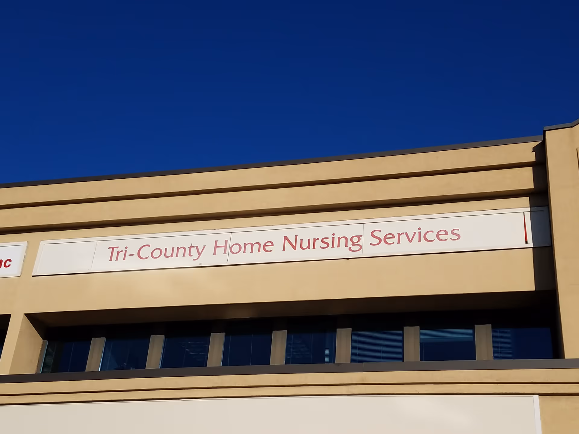 Facade of a beige building with a Tri-County Home Nursing Services sign.