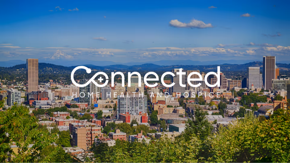 City skyline with trees in foreground and a large Connected Home Health logo.