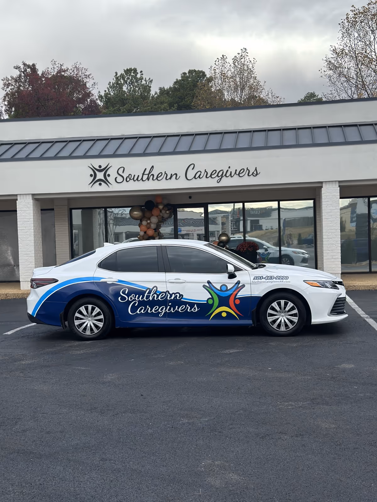 Front view of Southern Caregivers building in Jonesboro with a branded car parked outside