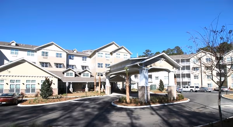 Exterior view of Mulligan Park Gracious Retirement Living with a covered entrance and driveway.