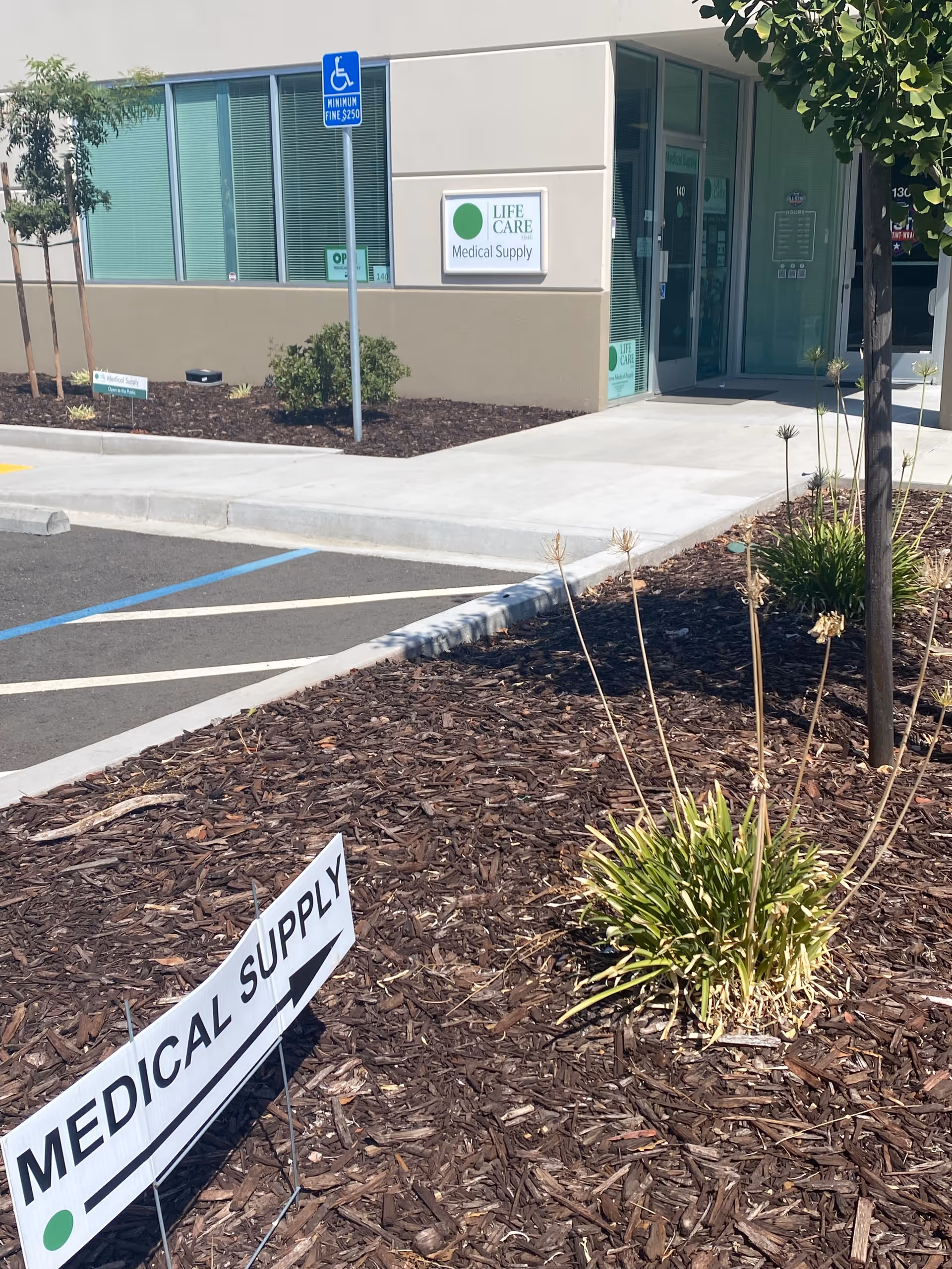 Exterior view of Life Care Medical Supply storefront with parking and landscaping.