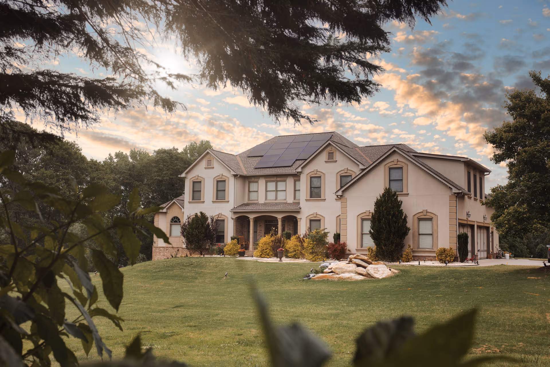 Exterior of Dee Kennedy Senior Care Home: two-story beige building with solar panels and landscaped yard.