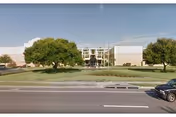 Wide exterior view of Presbyterian Villas of Tampa with trees, lawn, and road.