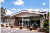 Exterior view of Potomac Valley Rehabilitation and Healthcare Center entrance with planters.