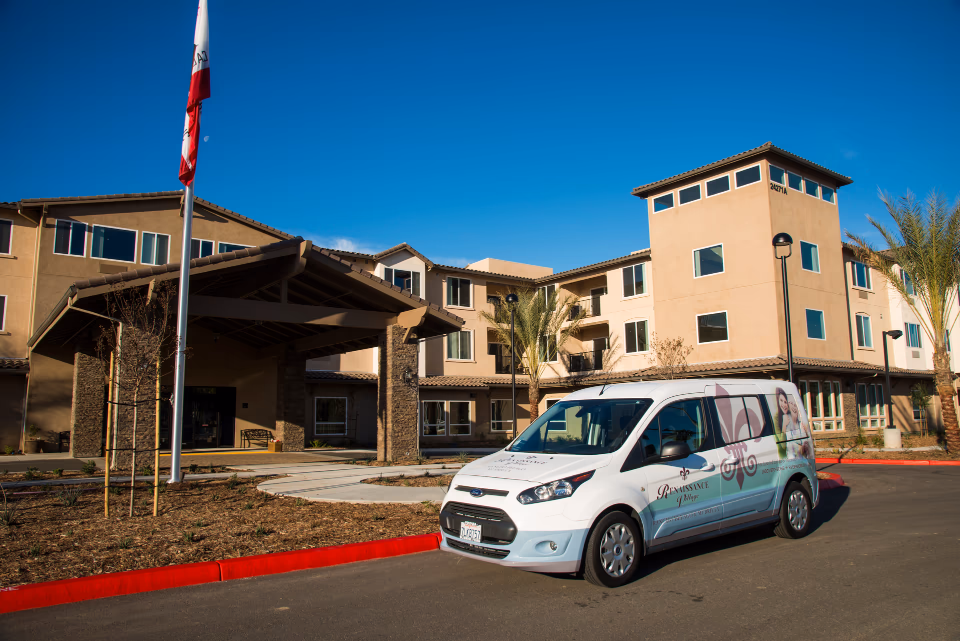 Exterior view of Renaissance Village Murrieta with a white promotional van parked in front.