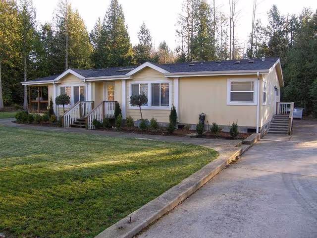 Taylor Adult Family Home exterior: a single-story beige building with a front yard and driveway.