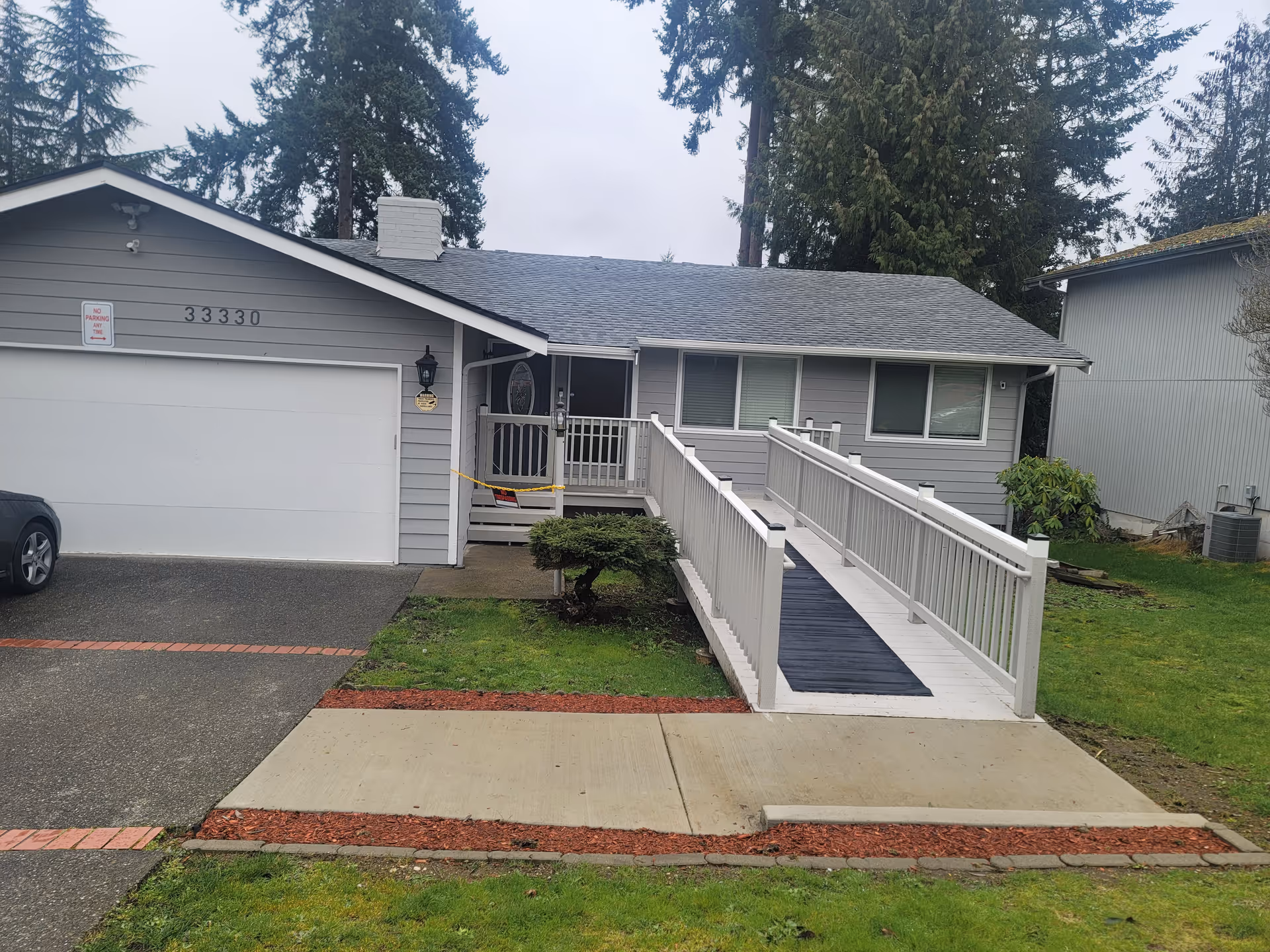 Front exterior of Royal House adult family home with a wheelchair ramp.