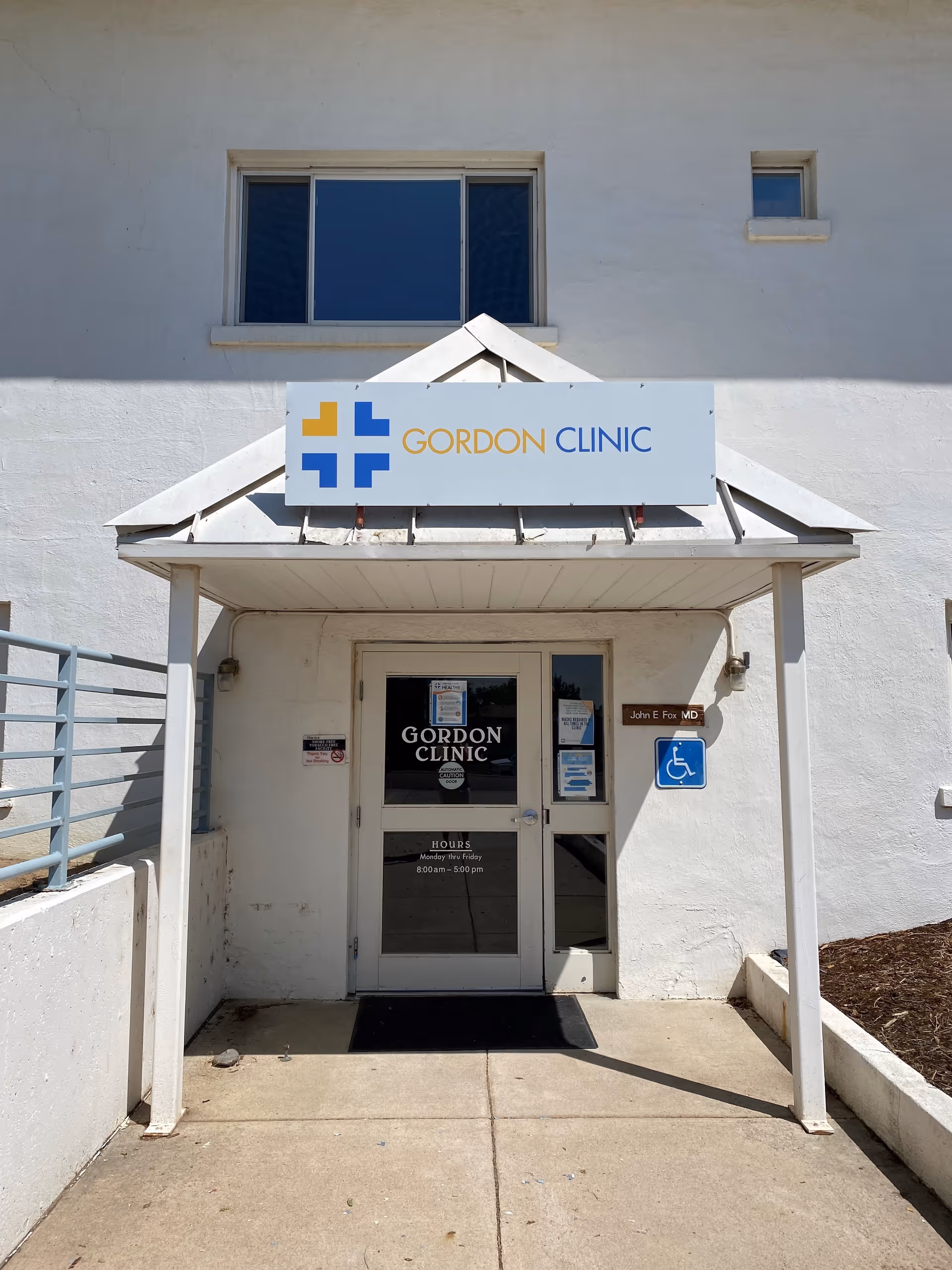 White clinic entrance with Gordon Clinic sign above a glass door.