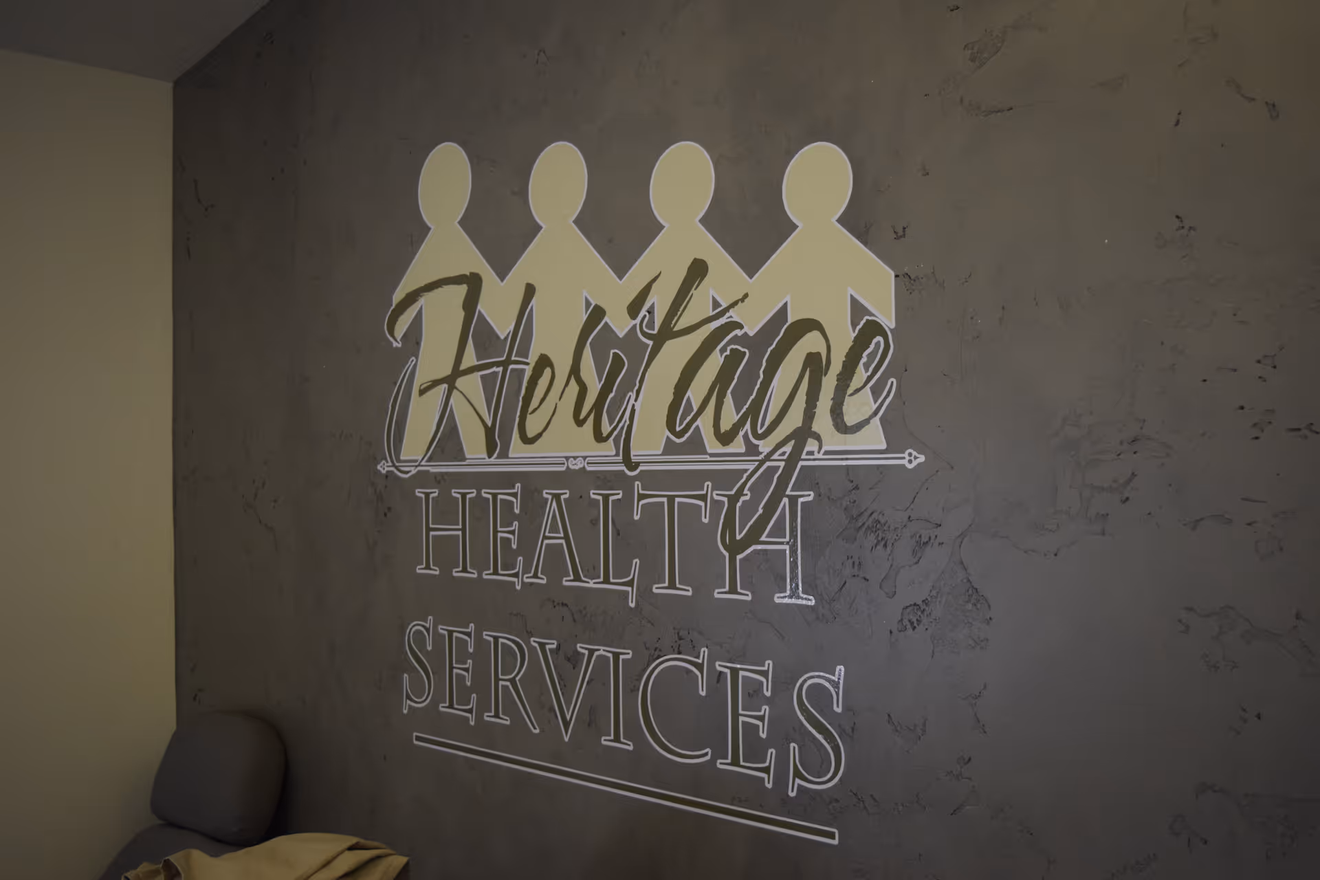 Interior wall featuring Heritage Health Services logo and crown silhouettes.