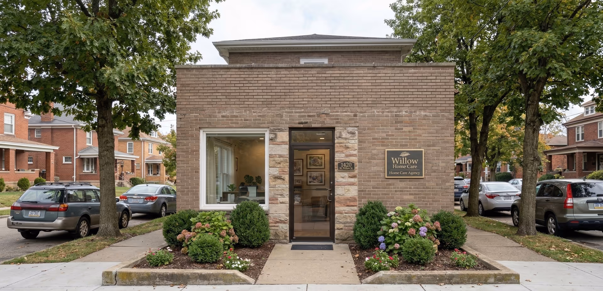 Brick facility with glass door entrance, a Willow Home Care sign, and landscaped front garden.