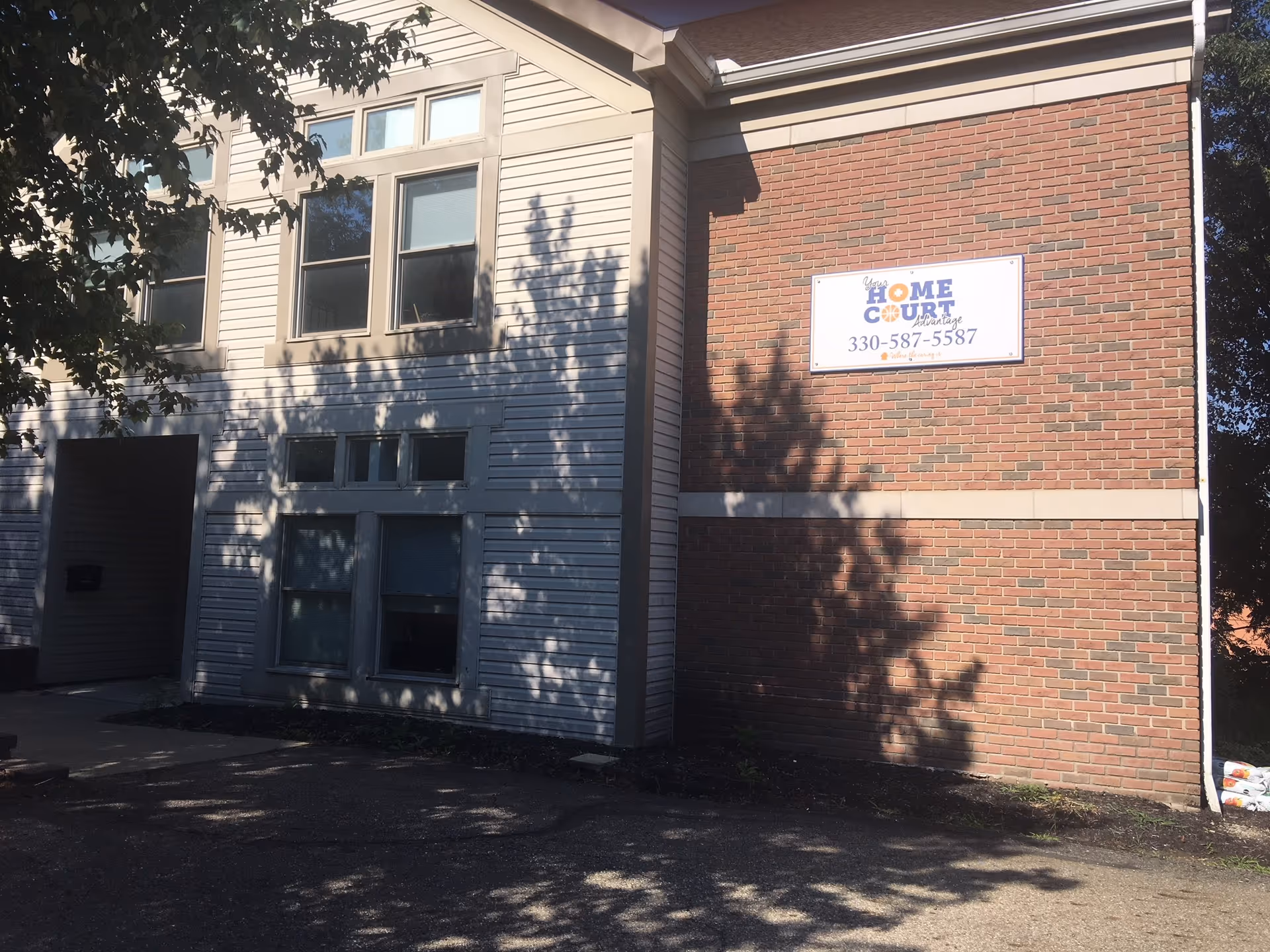 Exterior view of a senior living facility with a sign reading Home Court Advantage