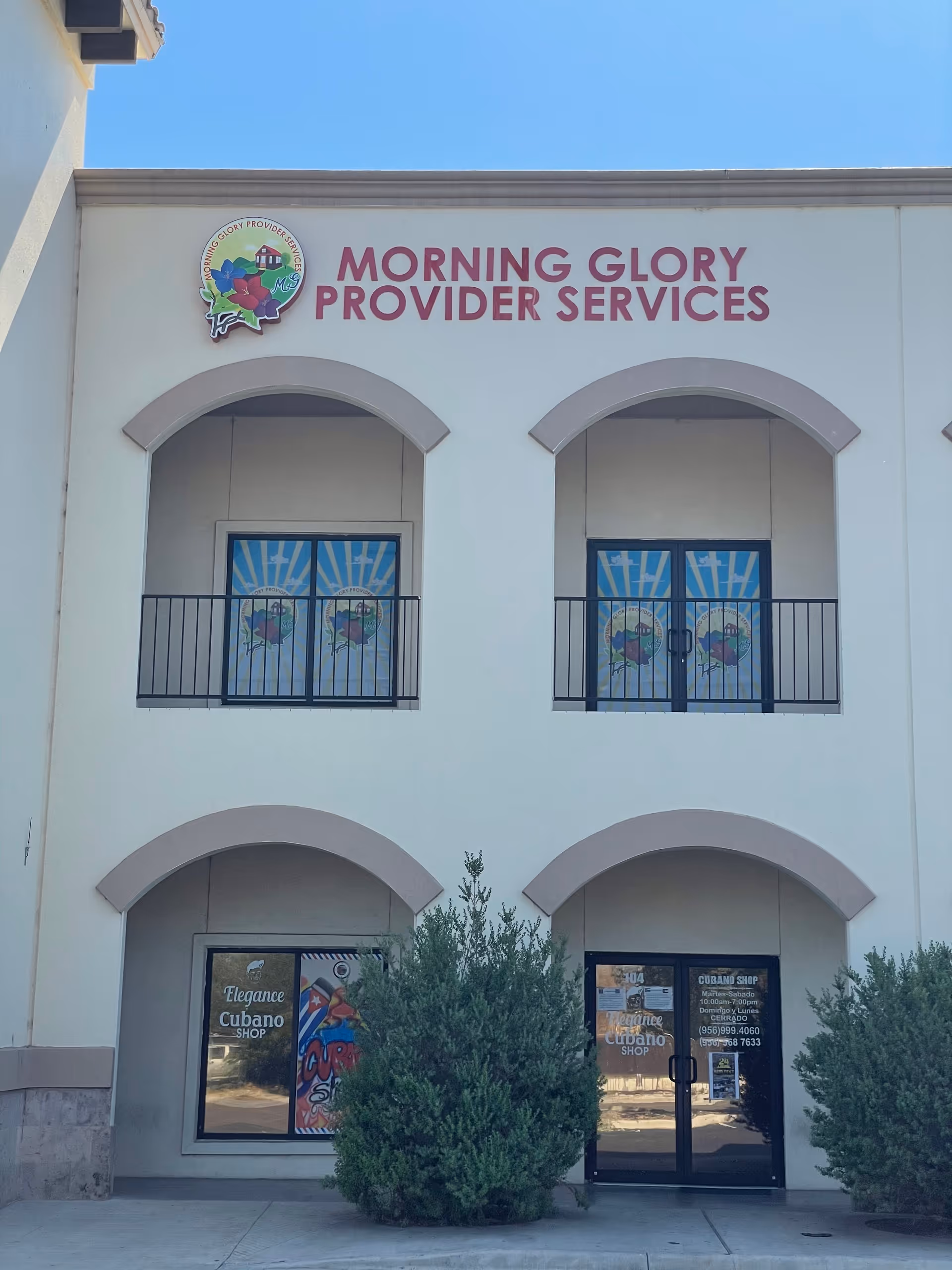 Front view of Morning Glory Provider Services building with arched windows and storefronts.