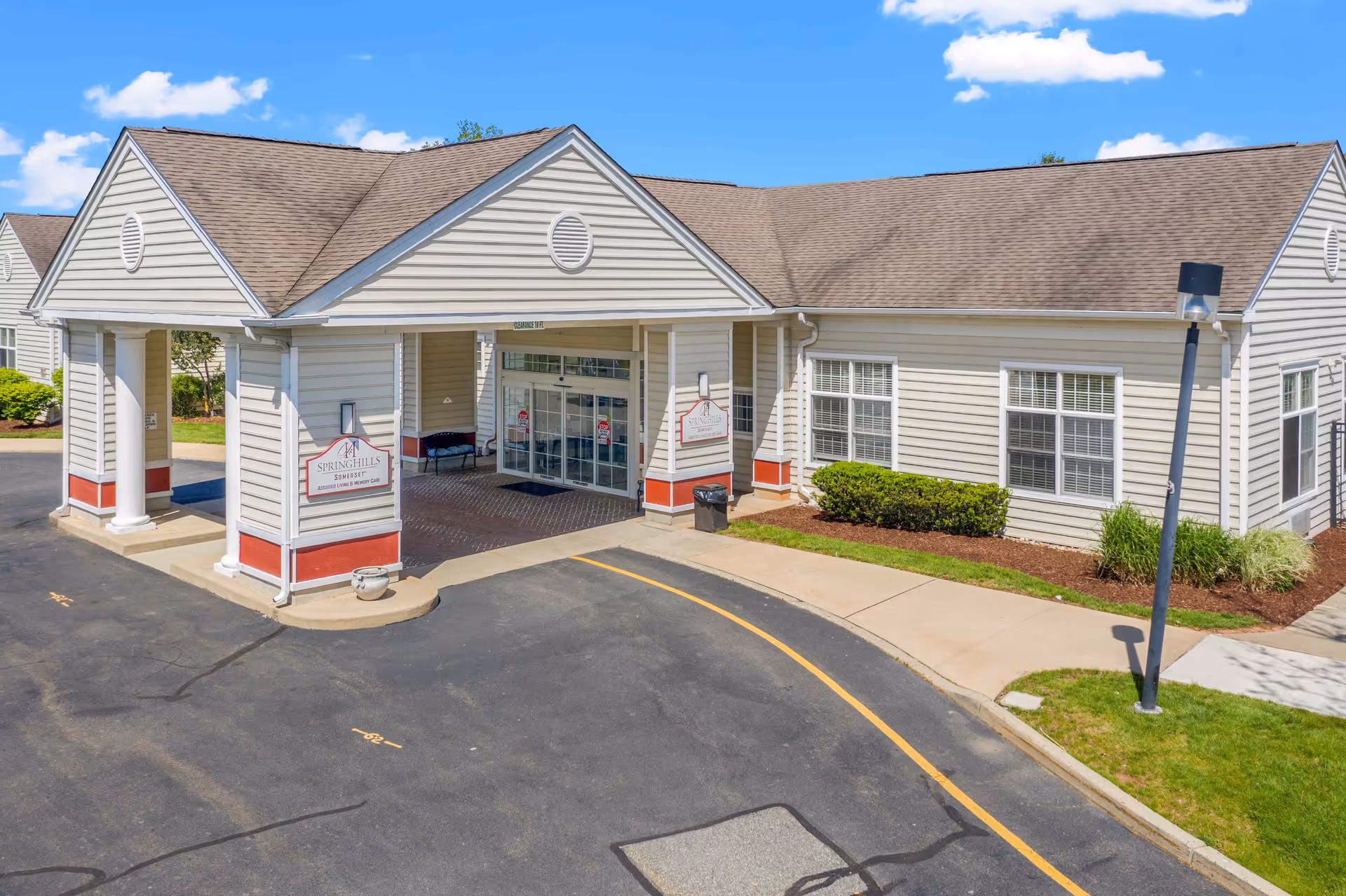 Exterior view of Spring Hills Somerset with a covered entrance and driveway