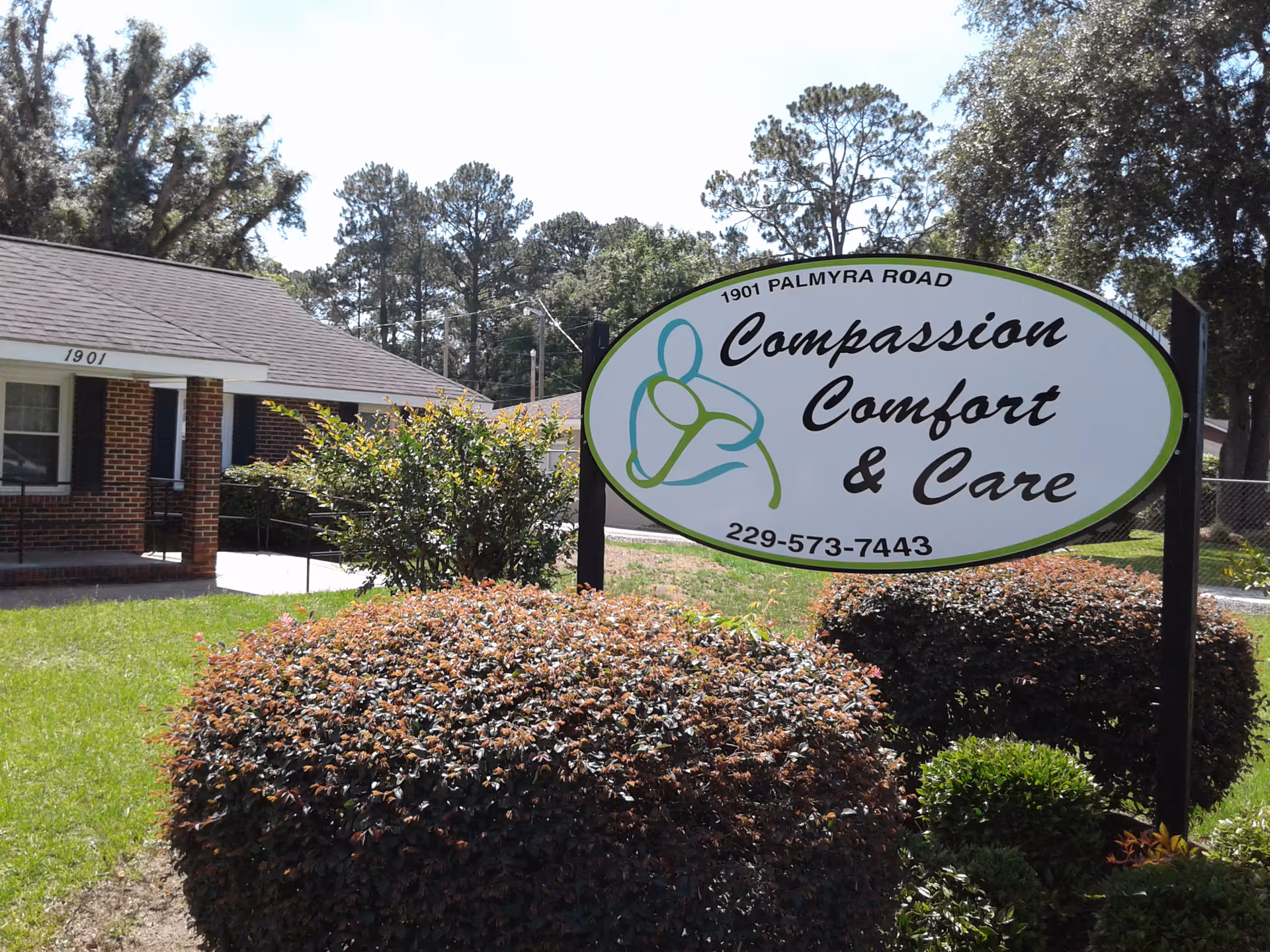 Sign for Compassion Comfort & Care in front of a brick facility