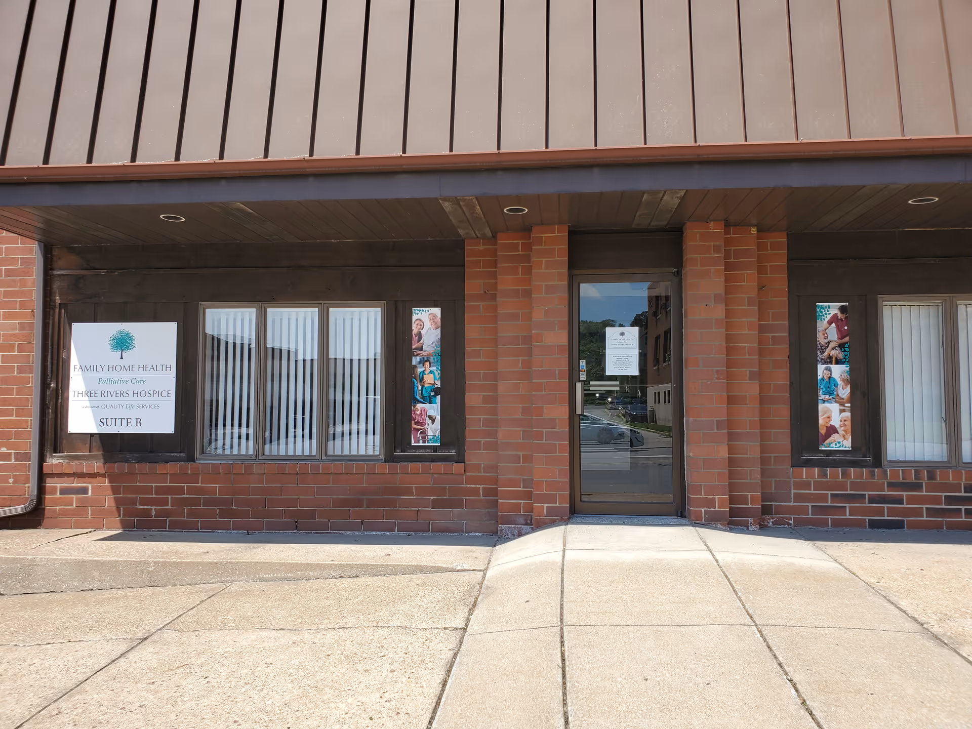 Brick storefront with windows and a door, signage for Family Home Health & Three Rivers Hospice.