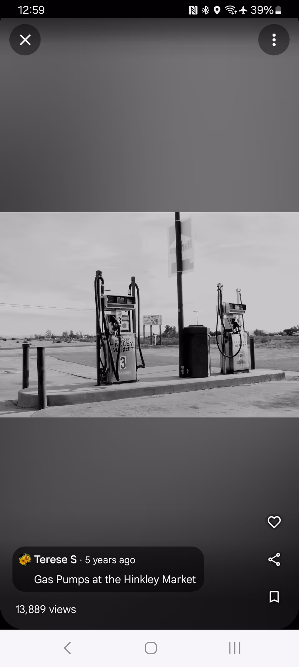 Two vintage gas pumps at a desolate outdoor gas station.