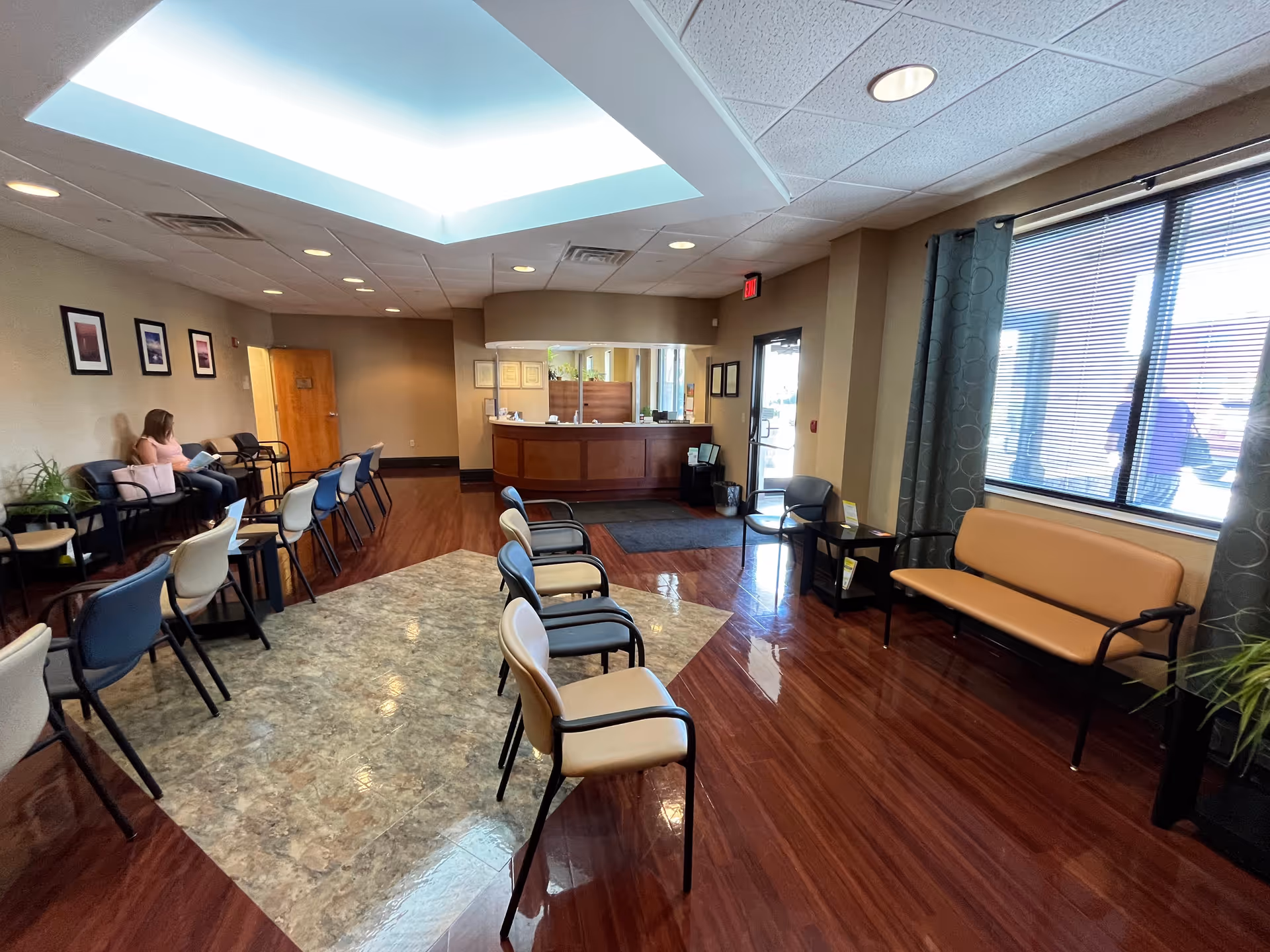 Interior lobby of a senior living center with chairs and a reception desk.