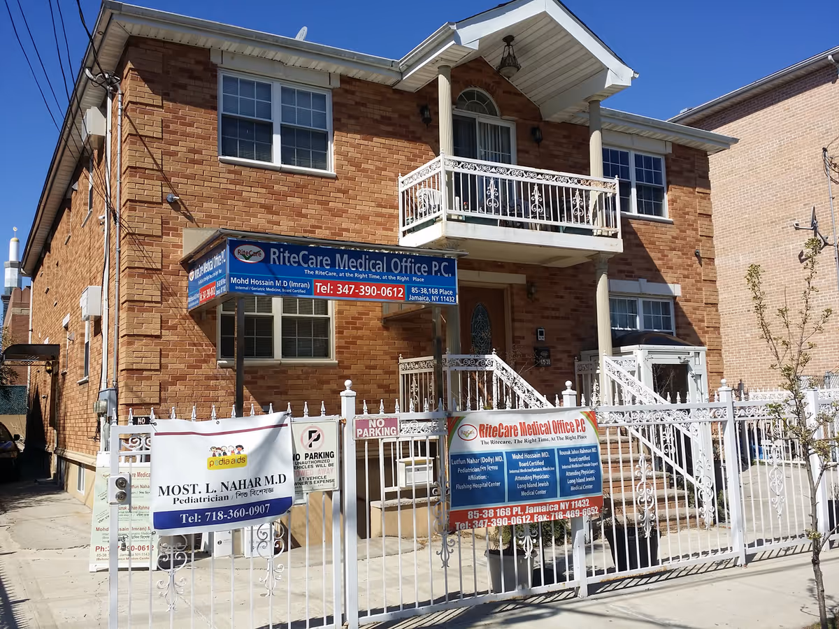 Two-story brick building with RiteCare Medical Office sign and white decorative fencing.