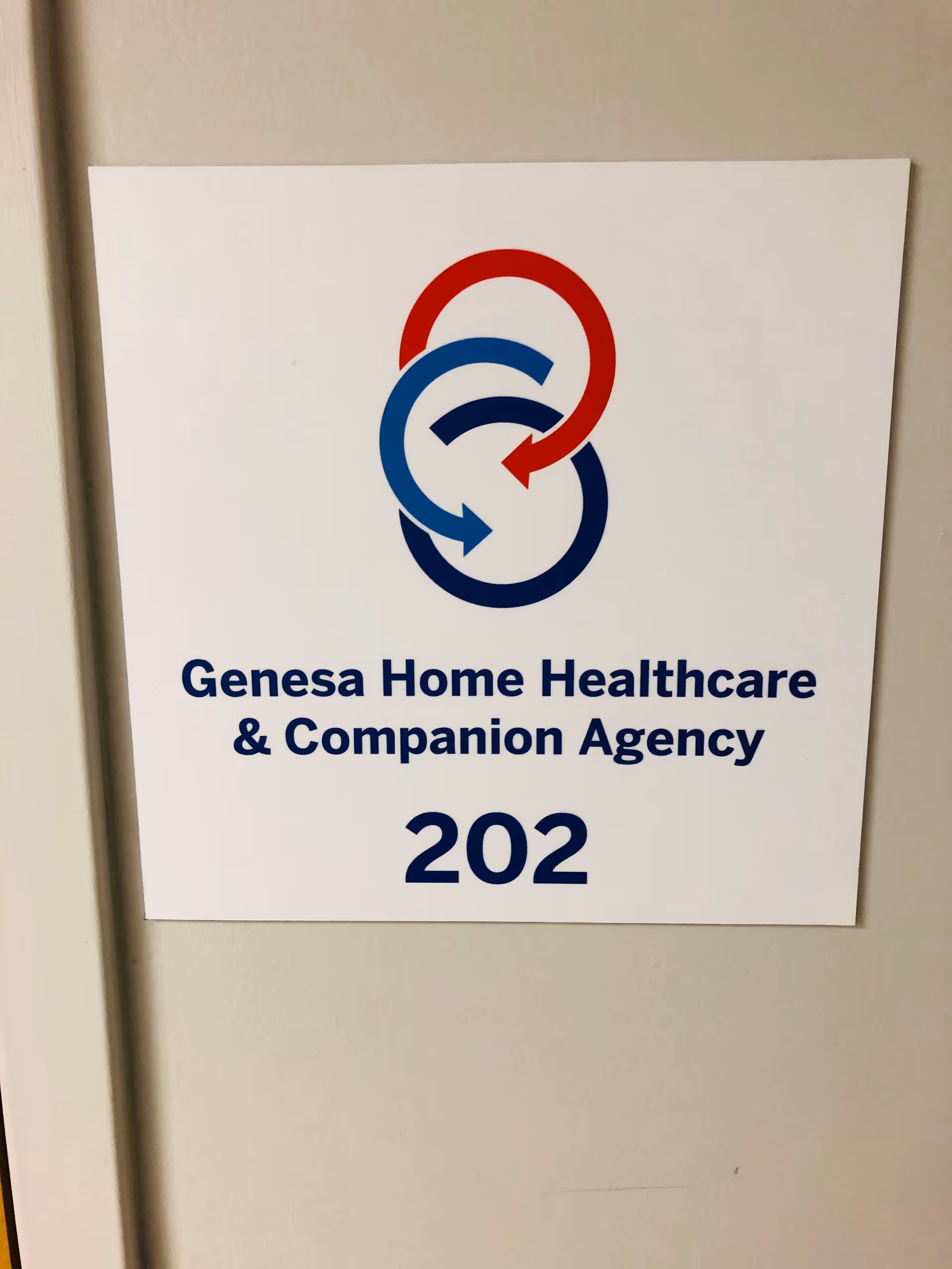 Sign on wall displaying Genesa Home Healthcare & Companion Agency logo and room number 202.