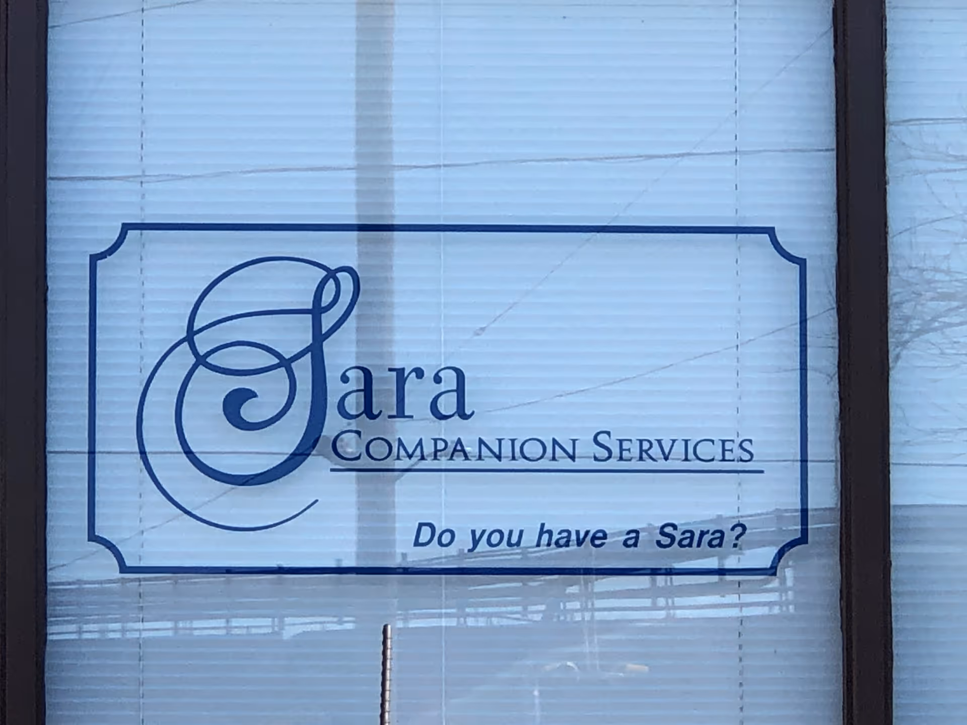 Window sign displays Sara Companion Services logo and slogan 'Do you have a Sara?'