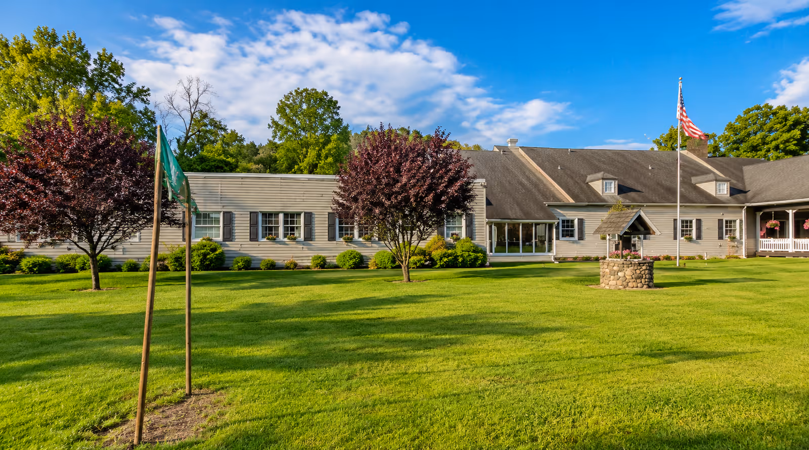 Exterior view of Darway Healthcare and Rehabilitation Center with a manicured lawn and flagpole.