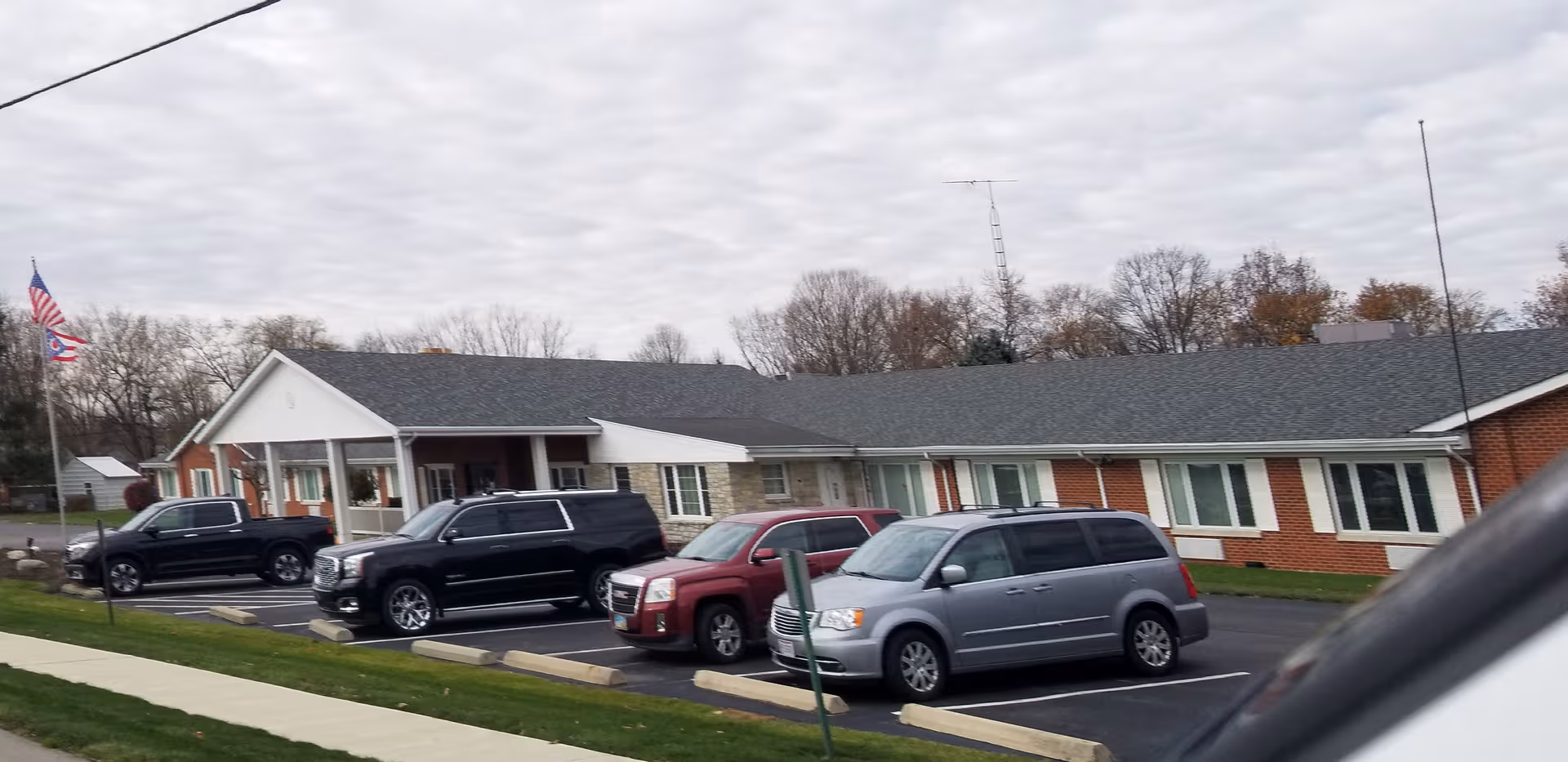 Exterior view of Rest Haven senior living facility with parked cars in front.