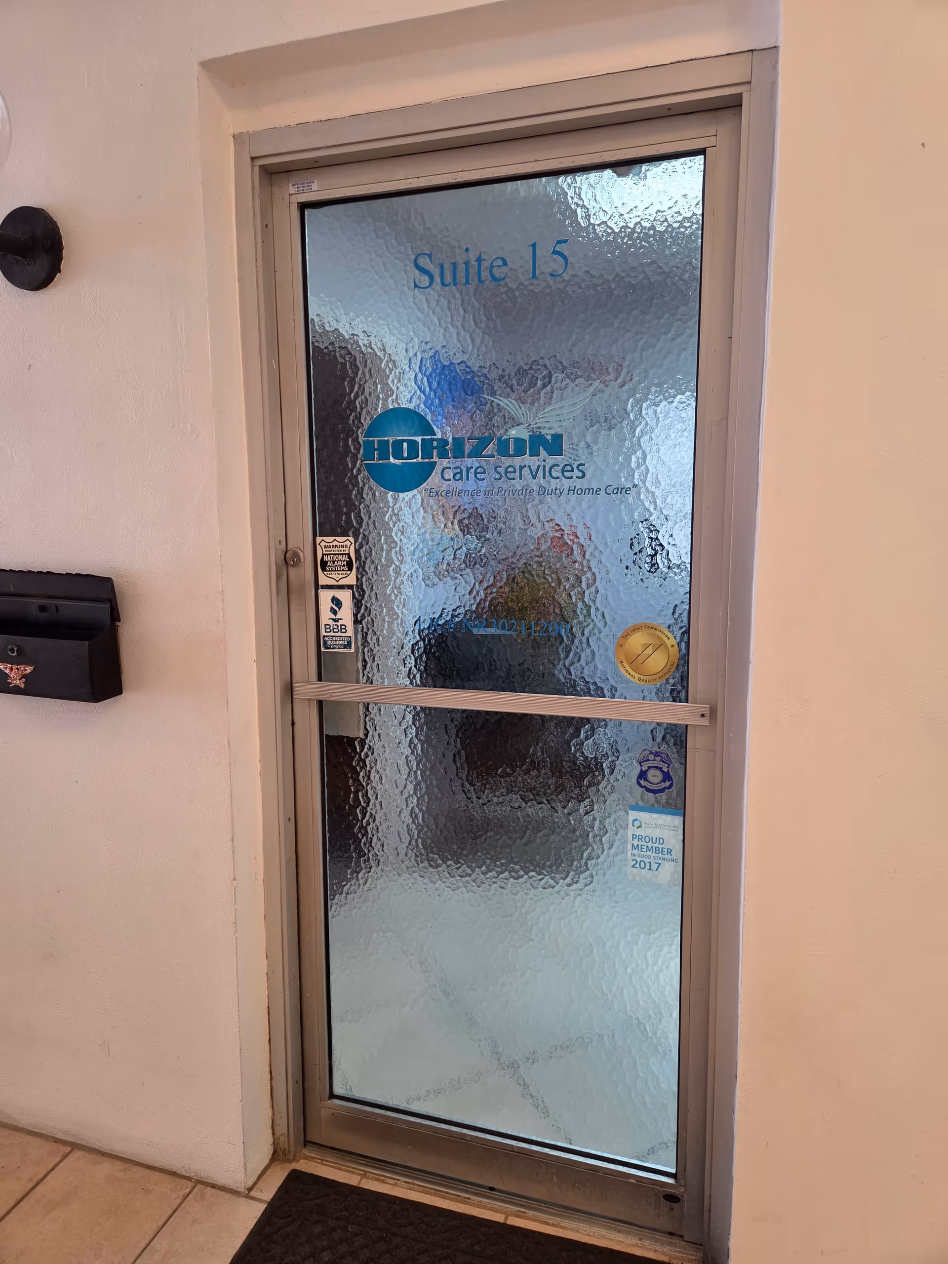 Frosted glass door labeled Suite 15 with Horizon Care Services logo in a hallway