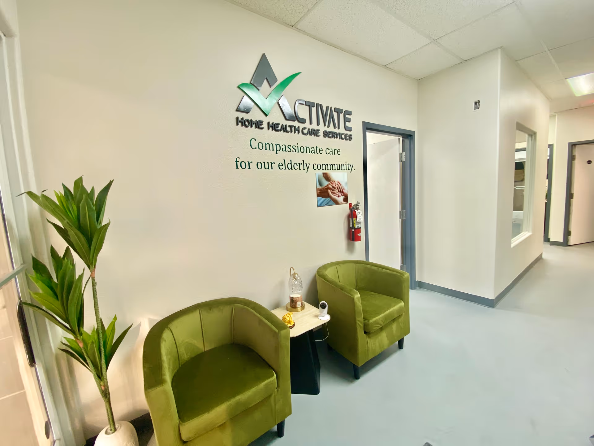 Lobby seating area with green chairs and Activate Home Health Care sign