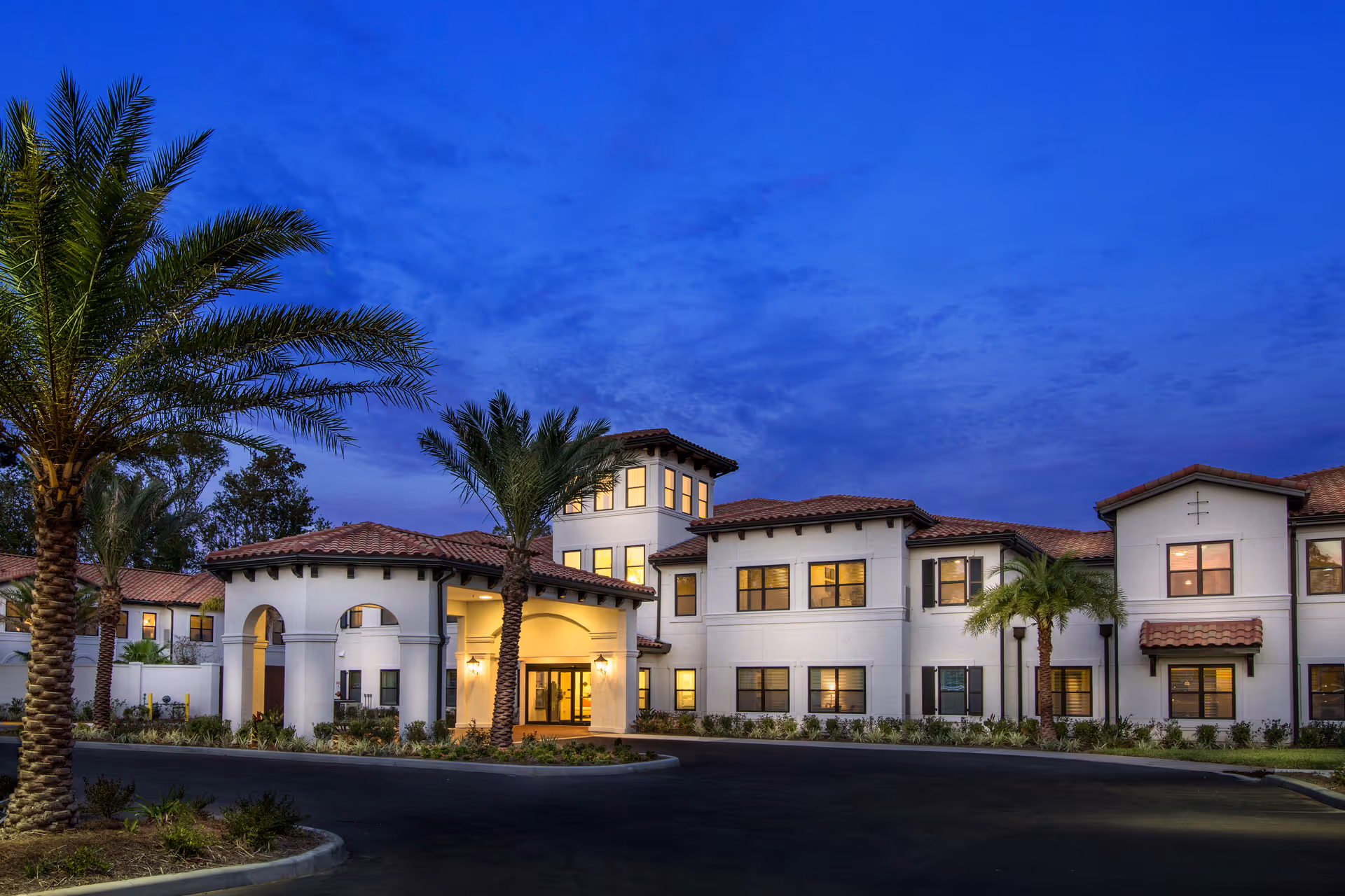 Exterior view of Starling at San Jose facility with palm trees at dusk.