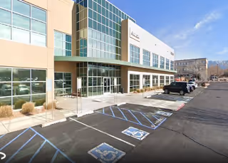 Exterior of Giving Home Health Care facility with parking lot and blue handicapped spots.