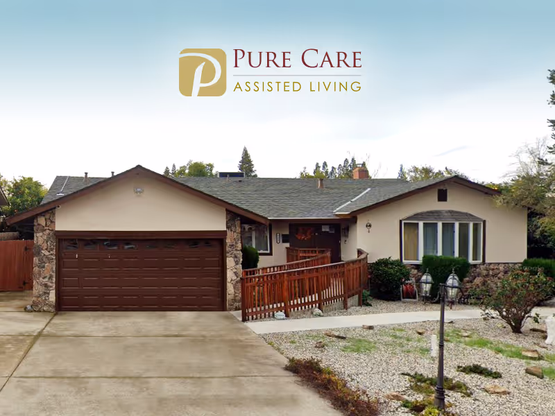 Front exterior of a single-story assisted living home with a Pure Care logo above.