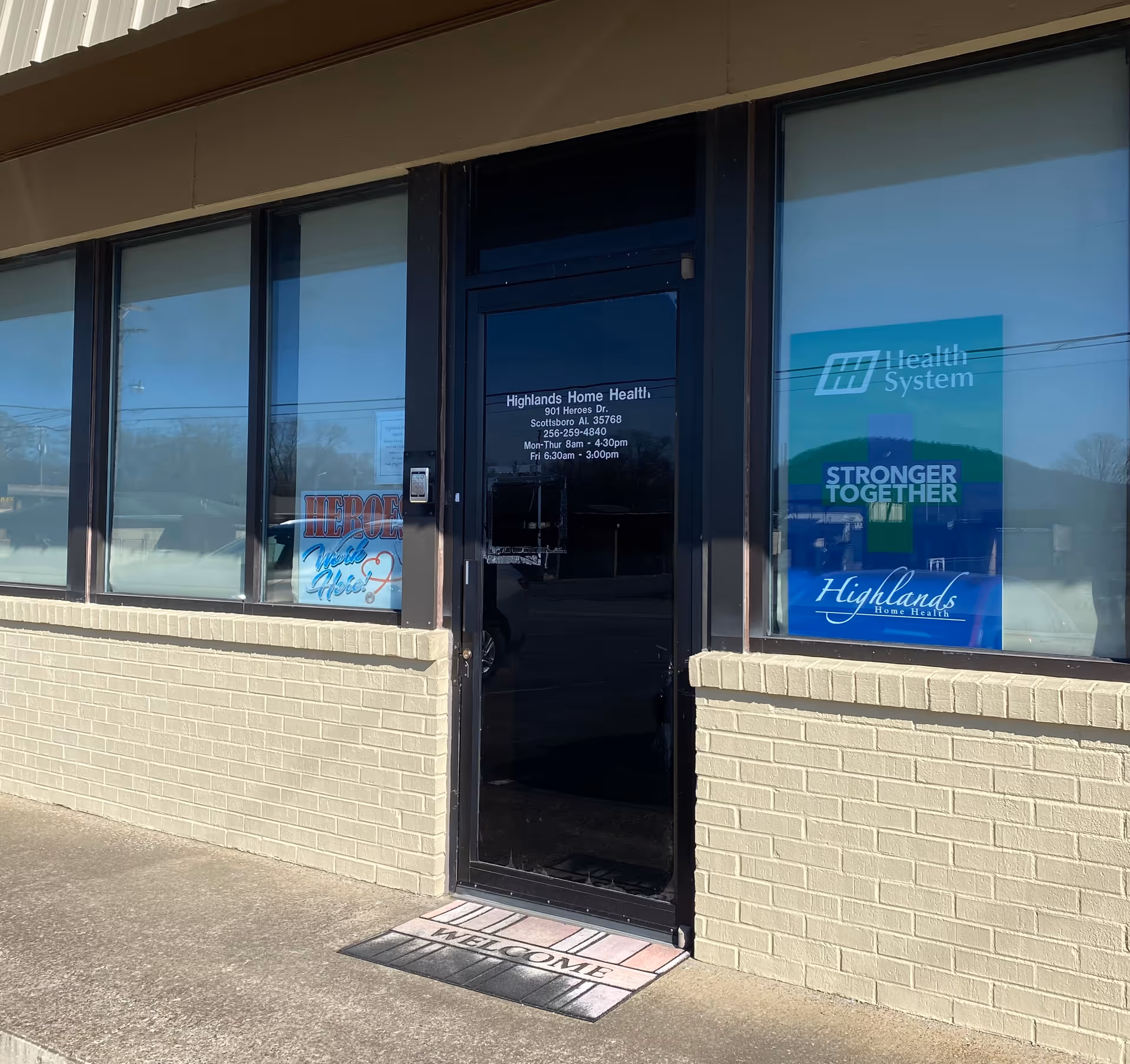 Exterior view of Highlands Home Health entrance with glass door and large windows