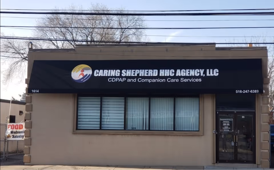 Front exterior of Caring Shepherd HHC Agency LLC building with large sign and windows