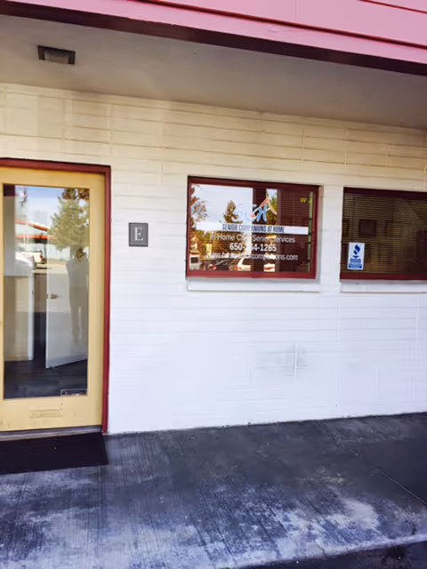 Exterior view of a Senior Companions At Home facility entrance with a window.