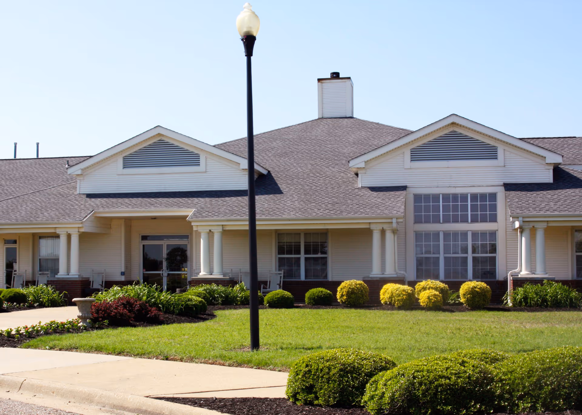Exterior view of StoneBridge Senior Living facility featuring landscaped grounds and a prominent entrance.