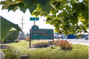 Exterior scene with Northridge Center sign amid landscaped trees and shrubs.