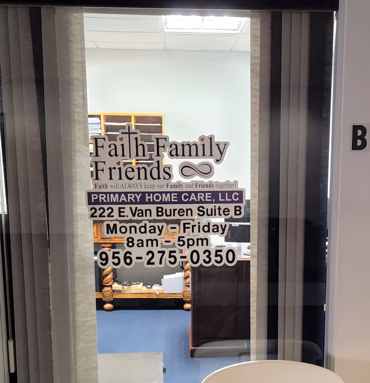 Glass doorway with Faith Family Friends branding and business details displayed on the door