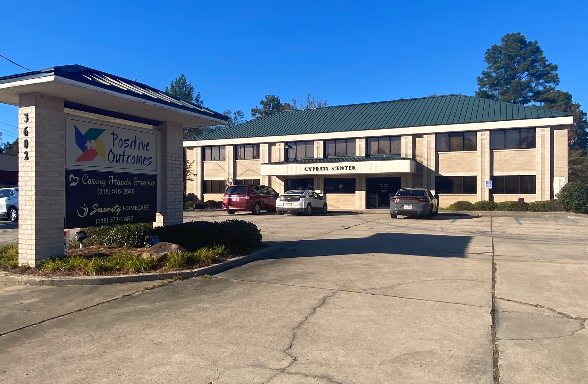 Exterior view of Caring Hands Hospice building with signage and a parking lot.