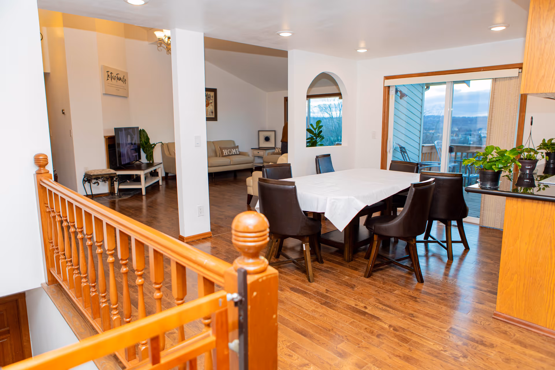 Open dining area with a table, chairs, and sliding glass doors to a balcony.