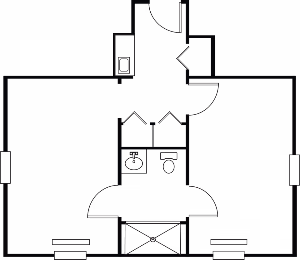 Architectural floor plan of a living space with two main rooms, a central bathroom featuring a sink and toilet, and an entry area with doors and closets.