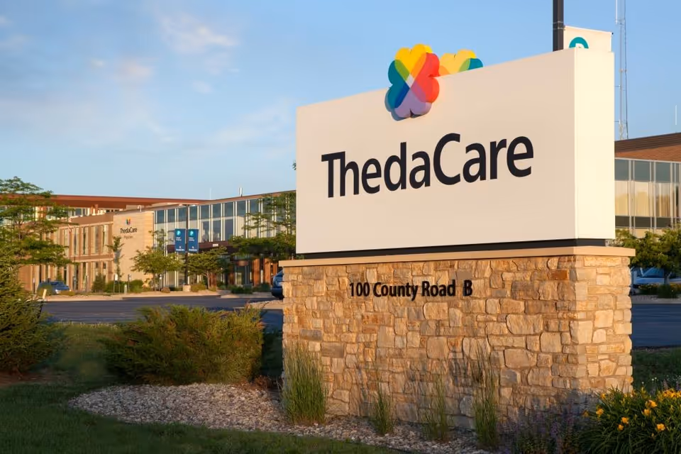 ThedaCare sign on a stone base with the facility building in the background.